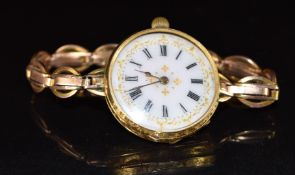 Unnamed 18ct gold ladies wristwatch with gold hands, black Roman numerals, gilt decorated white