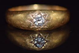 An 18ct gold ring set with a diamond of approximately 0.15ct in a star setting, 5.1g, size S