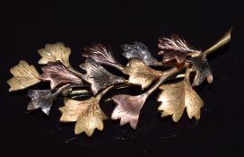 A 9ct gold tri-coloured brooch in a foliate design, 10.3g, 5.7cm