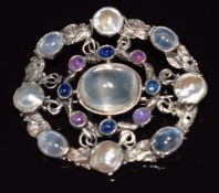 Arts and Crafts silver brooch set with mother of pearl, moonstone, ruby and sapphire cabochons