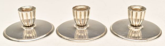 Set of three Georg Jensen hallmarked silver squat candlesticks, design number 897, marked Georg
