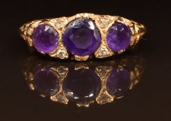 A 9ct gold ring set with three amethysts and diamonds, 2.4g, size M