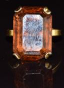 An 18ct gold ring set with an emerald cut citrine, 5.4g, size I