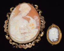 Victorian yellow metal brooch with holly decoration, set with a cameo depicting a man, signed