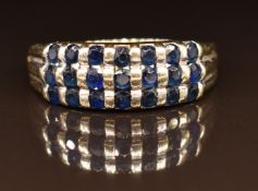 A 14k white gold ring channel set with sapphires, 4.2g, size V