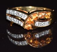 A 9k gold ring set with golden sapphires and diamonds, 4.3g, size N