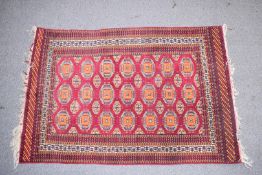 Turkoman rug with wine ground and geometric pattern to central section, 180 x 116cm