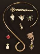 A collection of silver jewellery including a necklace, spider and other pendants including