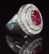 An 18ct white gold ring set with a synthetic ruby surrounded by diamonds, 12.9g, size N