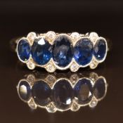 An 18ct white gold ring set with five graduated sapphires and diamonds, 3.3g, size M