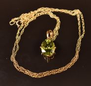 A 9ct gold pendant set with a peridot on 9ct gold chain, 1.4g