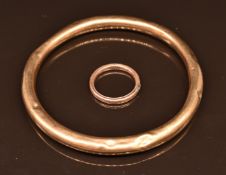 A 9ct rose gold flapper bangle and yellow metal ring, 10.9g