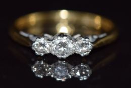A 18ct gold ring set with three diamonds in a platinum setting, 2.4g, size K