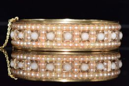 French gold Victorian bangle set with split pearls and coral cabochons, 5.5 x 4.6cm, 34.6g