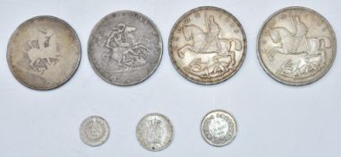 Two George III crowns, one about F, one poor, together with two George V 1935 rocking horse crowns