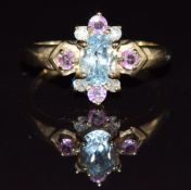 A 9k gold ring set with an oval cut blue topaz, pink sapphire and diamonds, 3.3g, size P