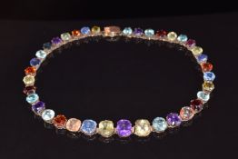 A c1900 rose gold necklace set with twelve natural Ceylon sapphires, the largest yellow 7ct and