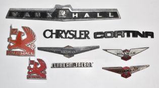 Nine enamel and other car badges to include Vauxhall, Hillman, Sunbeam Talbot, Chrysler and Ford
