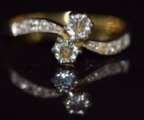 An 18ct gold' toi et moi' ring set with two diamonds in a twist setting, 3.6g, size Q