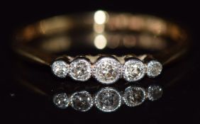 An 18ct gold ring set with five diamonds in a platinum setting, 2.1g, size Q