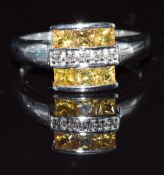 A 9k white gold ring set with yellow sapphires and diamonds, 3.2g, size N