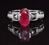 A 9k white gold ring set with an oval cut ruby and diamonds, 4.2g, size Q