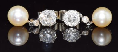 A pair of c1900 18ct white gold earrings each set with an old cut diamond of approximately 0.8ct and