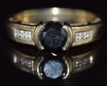 A 9ct gold ring set with a black diamond and diamonds, 3.2g, size M