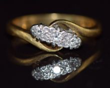An 18ct gold ring set with three diamonds in a platinum twist setting, 4g, size L
