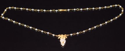 An 18ct gold necklace set with pearls, with a pendant section in the form of grapes set with further
