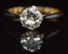 An 18ct gold ring set with a round cut diamond of approximately 1.2ct in a platinum setting, 3g,