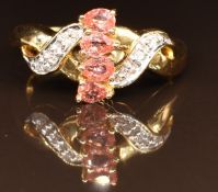 An 18k gold ring set with padparadsha sapphires and diamonds, 5g, size N