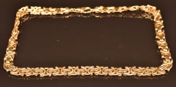 A 9ct gold necklace made up of cross shaped and elongated links, 30.1g, 40cm long