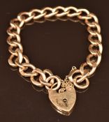 A 9ct gold curb link bracelet with heart padlock clasp, 26.7g