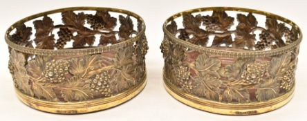 Pair of Georgian hallmarked silver gilt wine coasters with embossed decoration of vines, Sheffield
