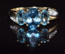 A 9ct gold ring set with oval cut blue topaz and diamonds, 2.7g, size Q
