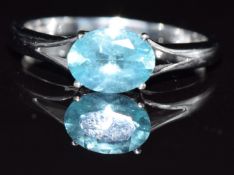 A 9k white gold ring set with a blue topaz, 1.9g, size O