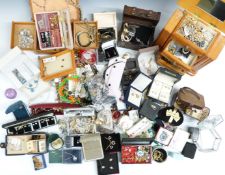 A collection of costume jewellery including brooches, necklaces, chains, bangles, necklaces