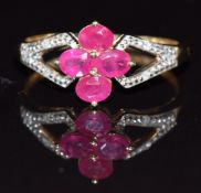 A 9ct gold ring set with four oval cut rubies and diamonds,1.8g, size N