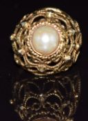 A yellow metal ring set with a pearl in a pierced setting, 5.1g, size H/I