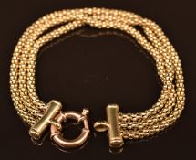 A triple strand 9ct gold bracelet, 14.1g, 36cm long