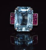 An 18ct white gold ring set with an emerald cut aquamarine of approximately 10.8cts and four