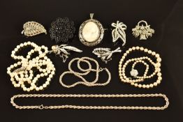 A silver pendant / brooch set with a cameo, double strand of cultured pearls, two silver chains,
