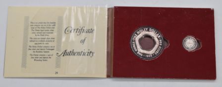 Australian Holy dollar and a dump silver coin, in presentation pack