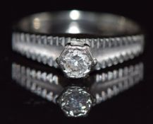 An 18ct white gold ring set with a diamond, 3.4g, size J
