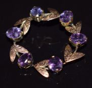 A 9k gold brooch set with synthetic purple colour change sapphires, 3.5cm diameter, 5.7g