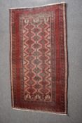 Turkoman rug with red ground and geometric pattern to central section, 191 x 90cm