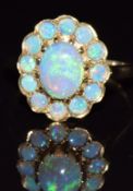 A 9ct gold ring set with a cluster of opals, 3.8g, size S