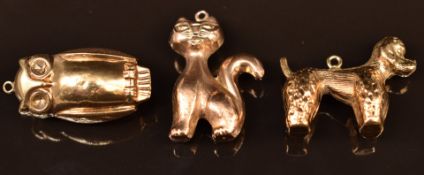 Three 9ct gold charms/ pendants comprising owl, cat and poodle, 5.4g