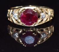 A 9k gold ring set with a round cut ruby and diamonds, 3.2g, size N